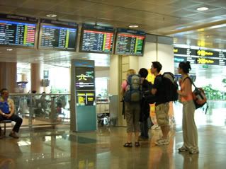 Travellers checking out their flights