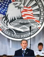 Bush speaking with September 11 emblem in background