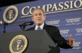 Bush speaking with word compassion in background